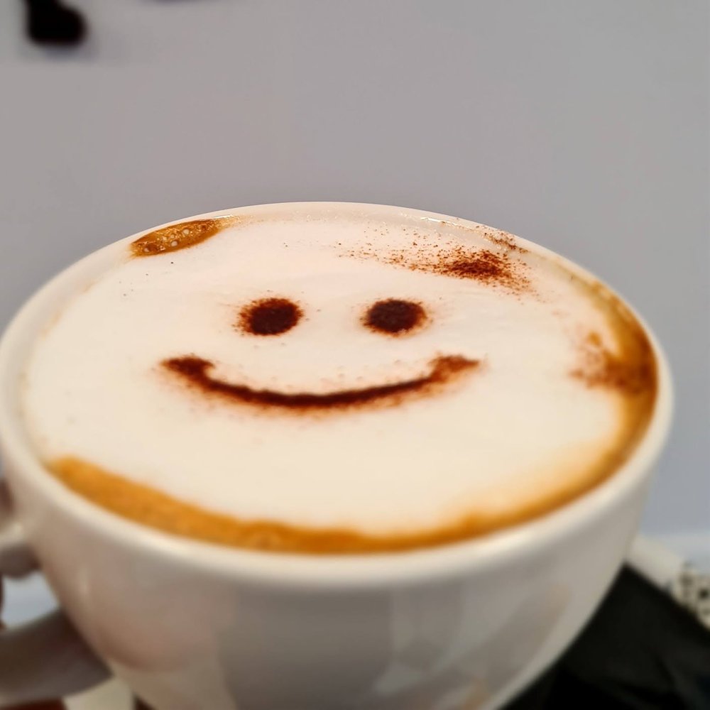 Cappuccino with a smiley face in chocolate powder